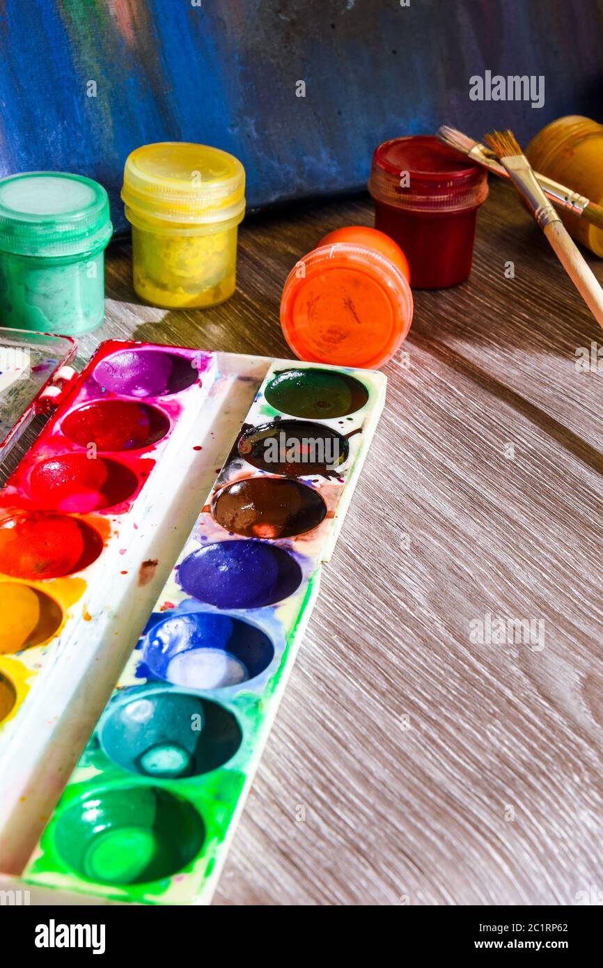 Tempera paints on the table in a selective focus, Set of