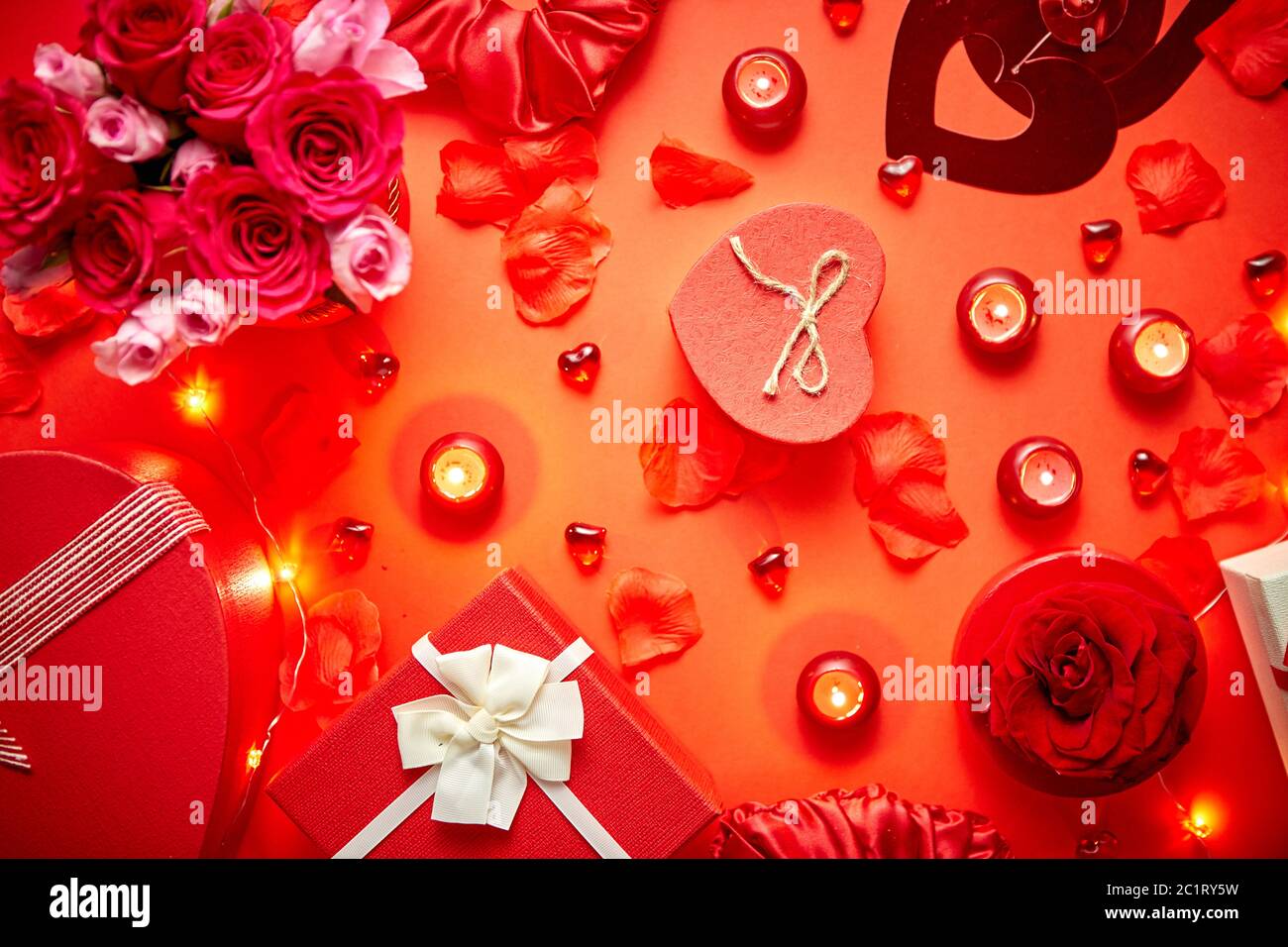 Valentines day romantic decoration with roses, boxed gifts, candles Stock Photo