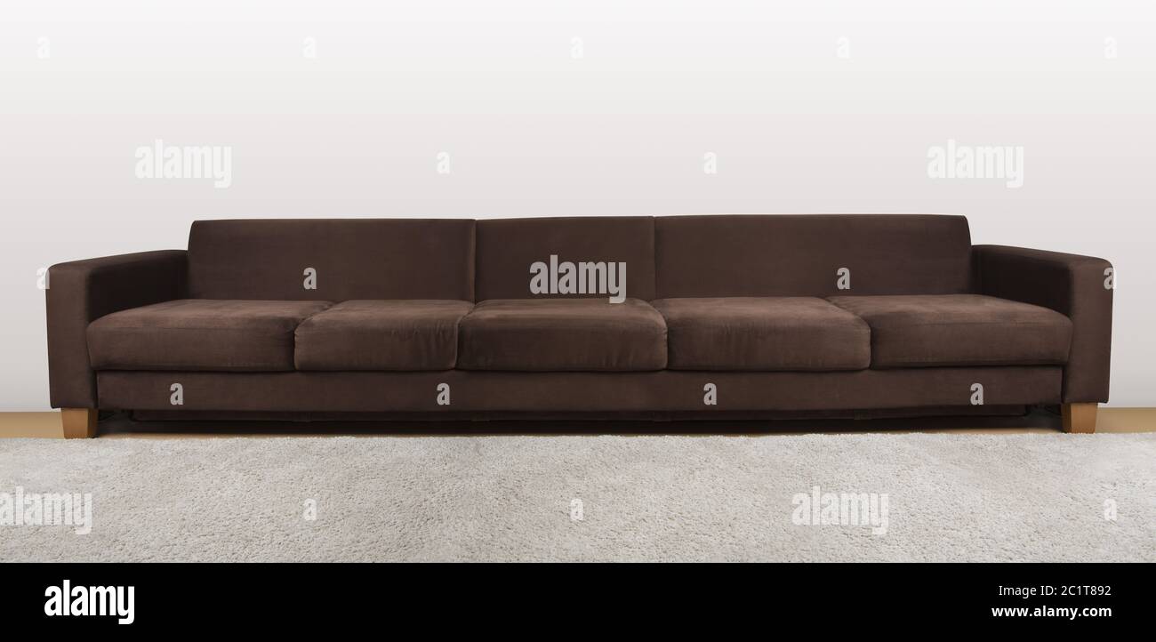 Large isolated cozy couch in brown color Stock Photo Alamy