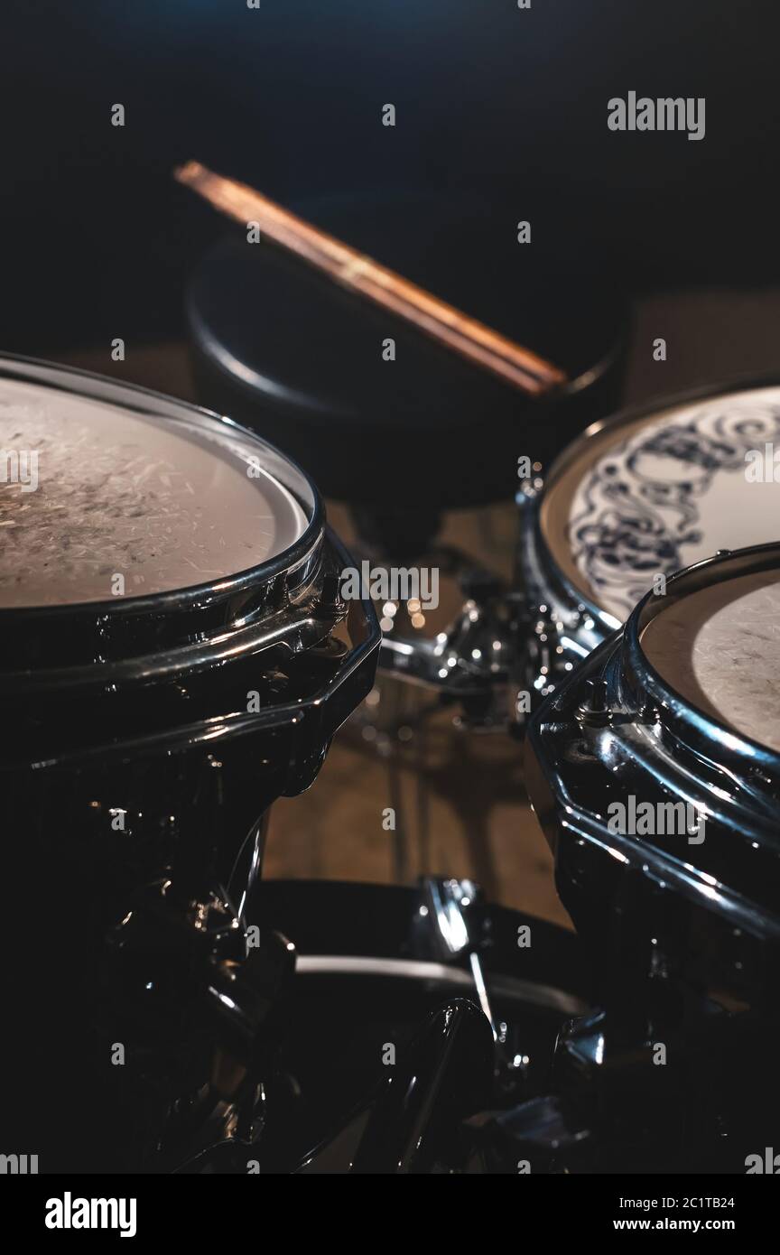 Closeup view of a drum set and Drumsticks in a dark studio. Black drum barrels with chrome trim. The concept of live performance Stock Photo - Alamy Closeup view of a drum set and Drumsticks in a dark studio. Black drum barrels with chrome trim. The concept of live performance Stock Photo - Alamy