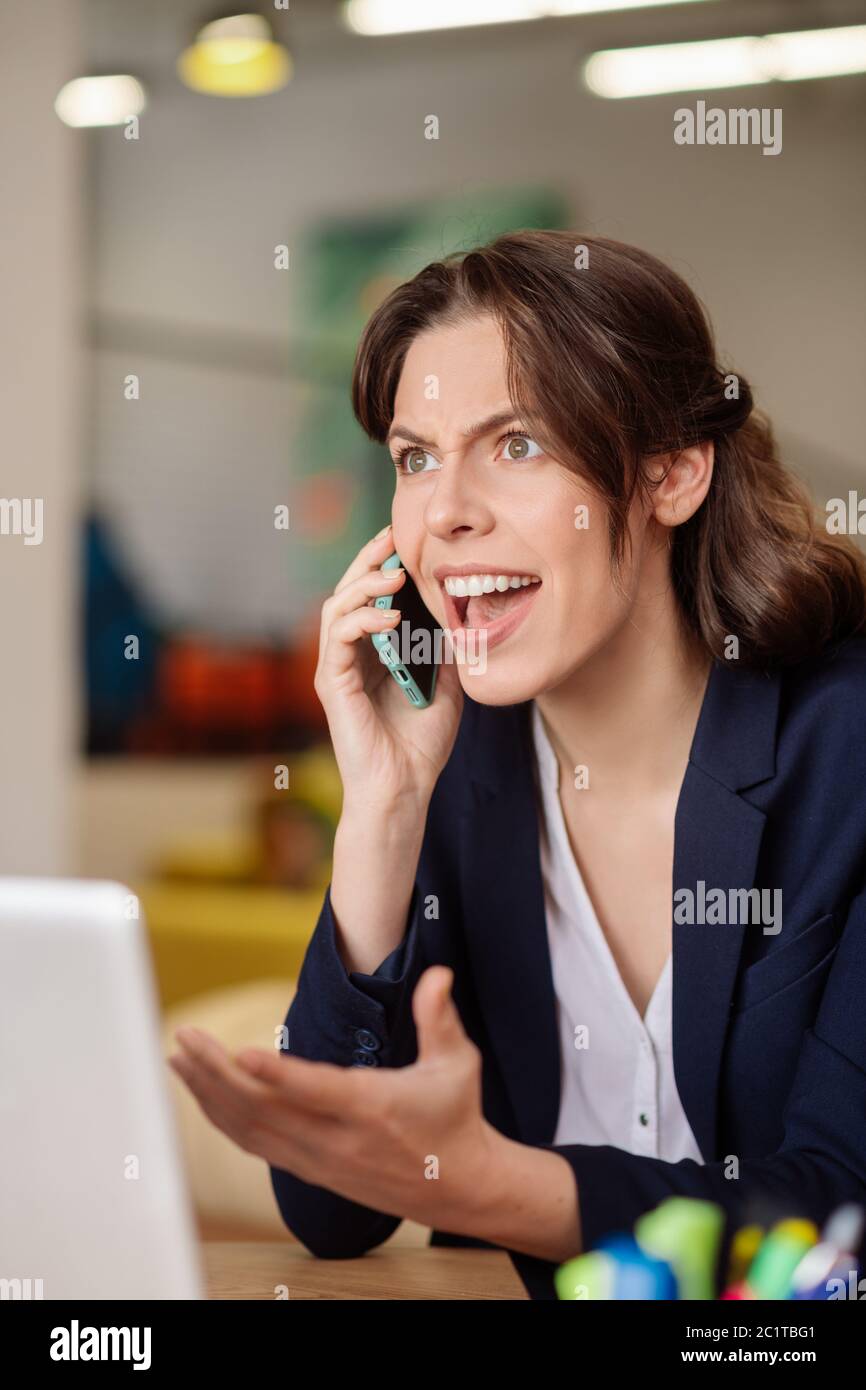 Frowning serious girl talking on a smartphone. Stock Photo