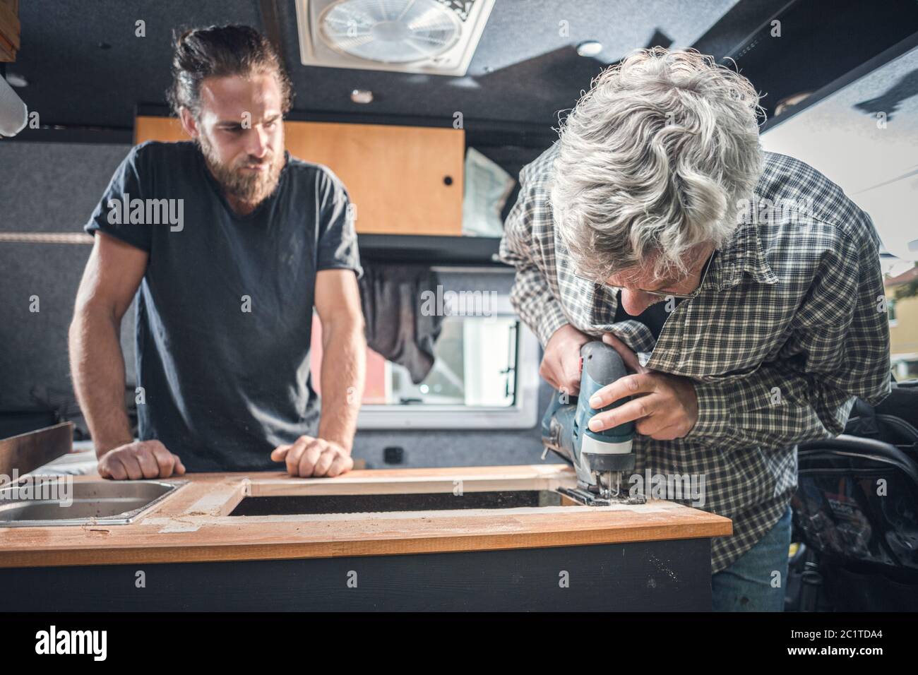 father-and-adult-son-working-on-a-camper-van-conversion-stock-photo-alamy