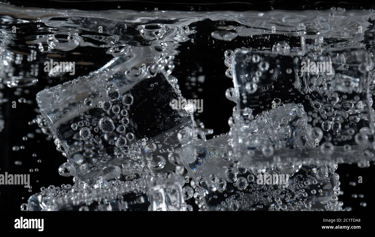 ice cube in fizzy splashing water with soda bubble Stock Photo - Alamy