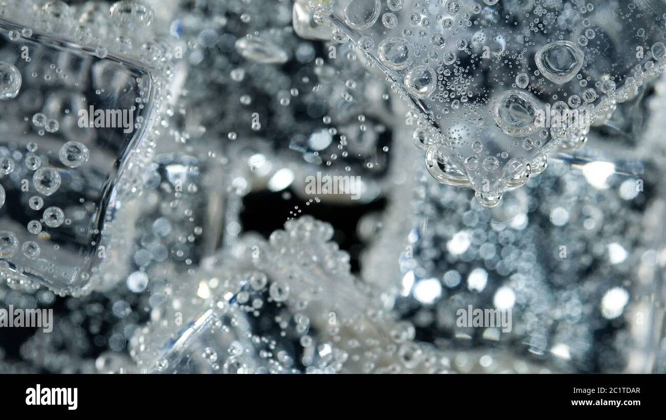 ice cube in fizzy splashing water with soda bubble Stock Photo - Alamy