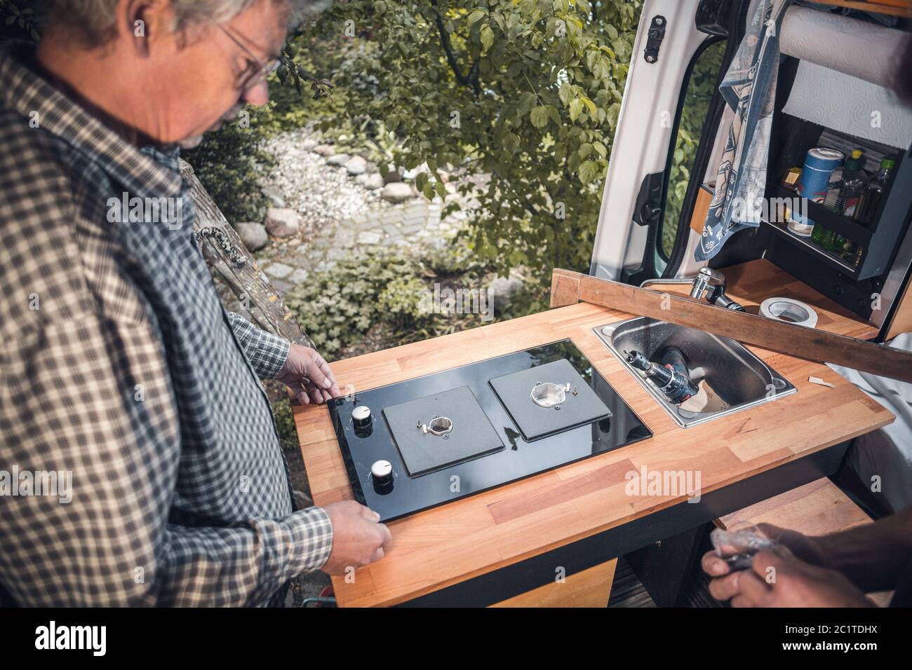 Installation of a stove into a camper van Stock Photo Alamy