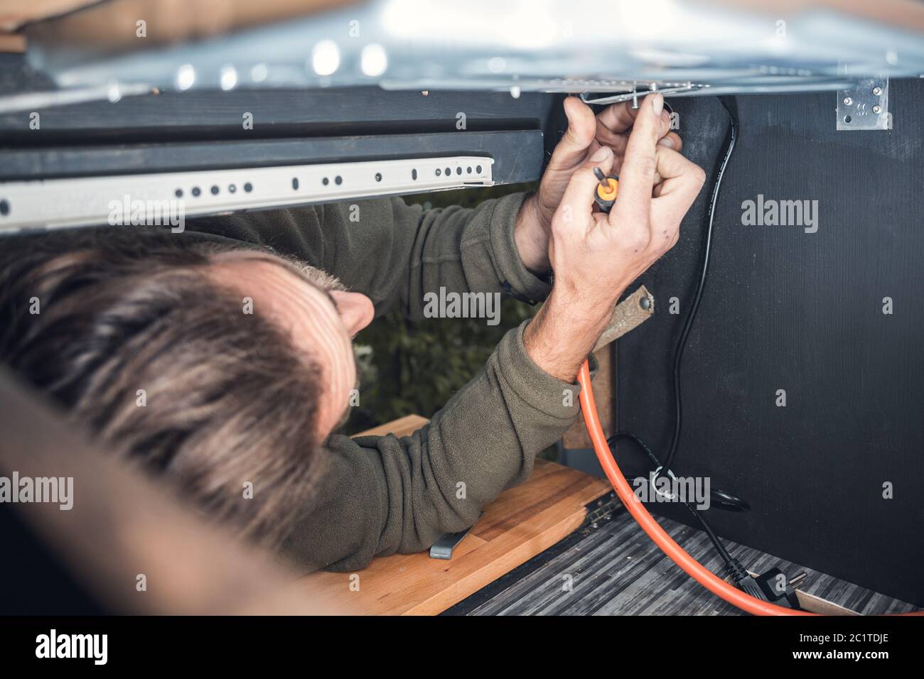 Man installing a gas stove Stock Photo Alamy