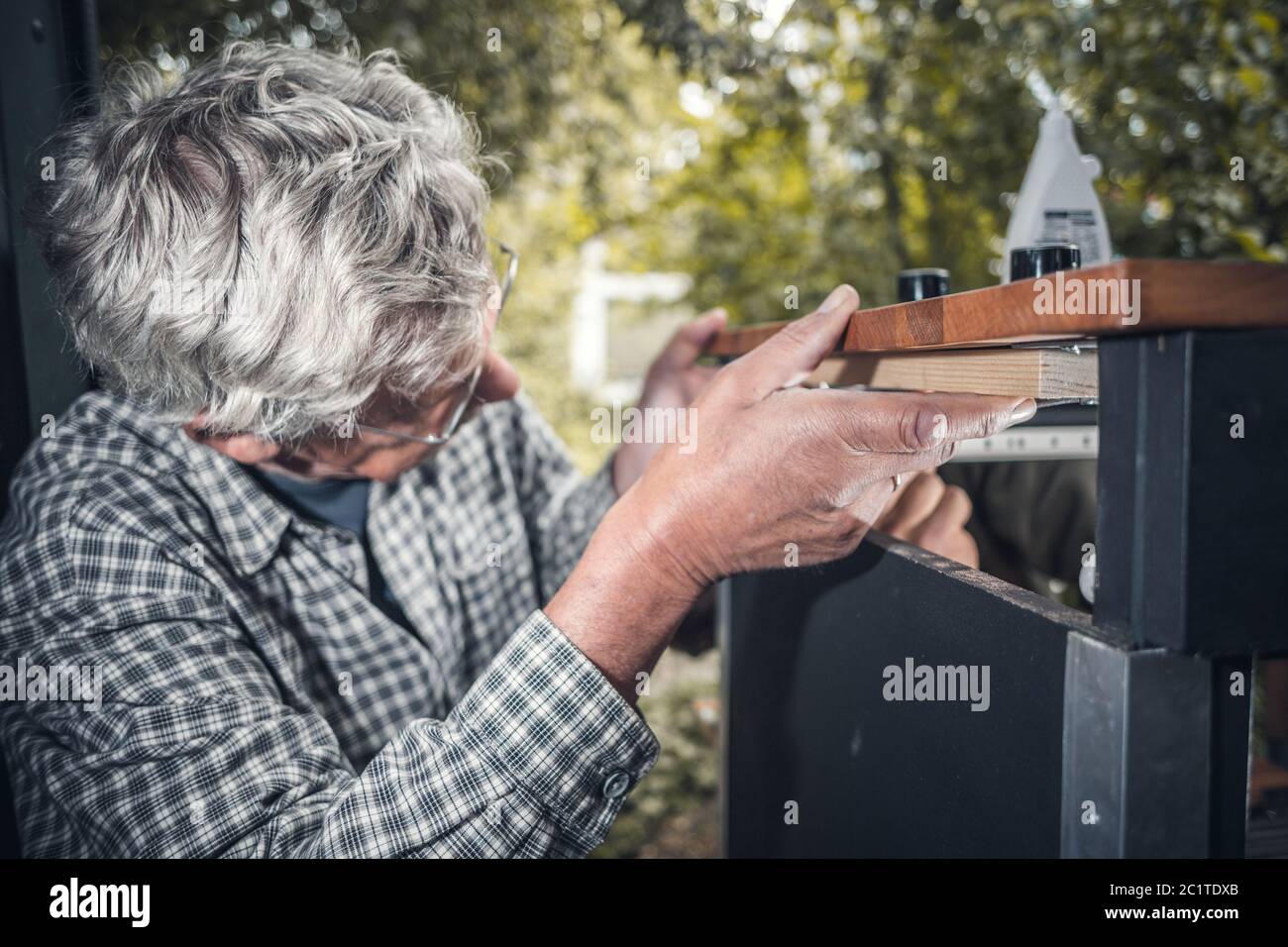 Senior man working with wood Stock Photo
