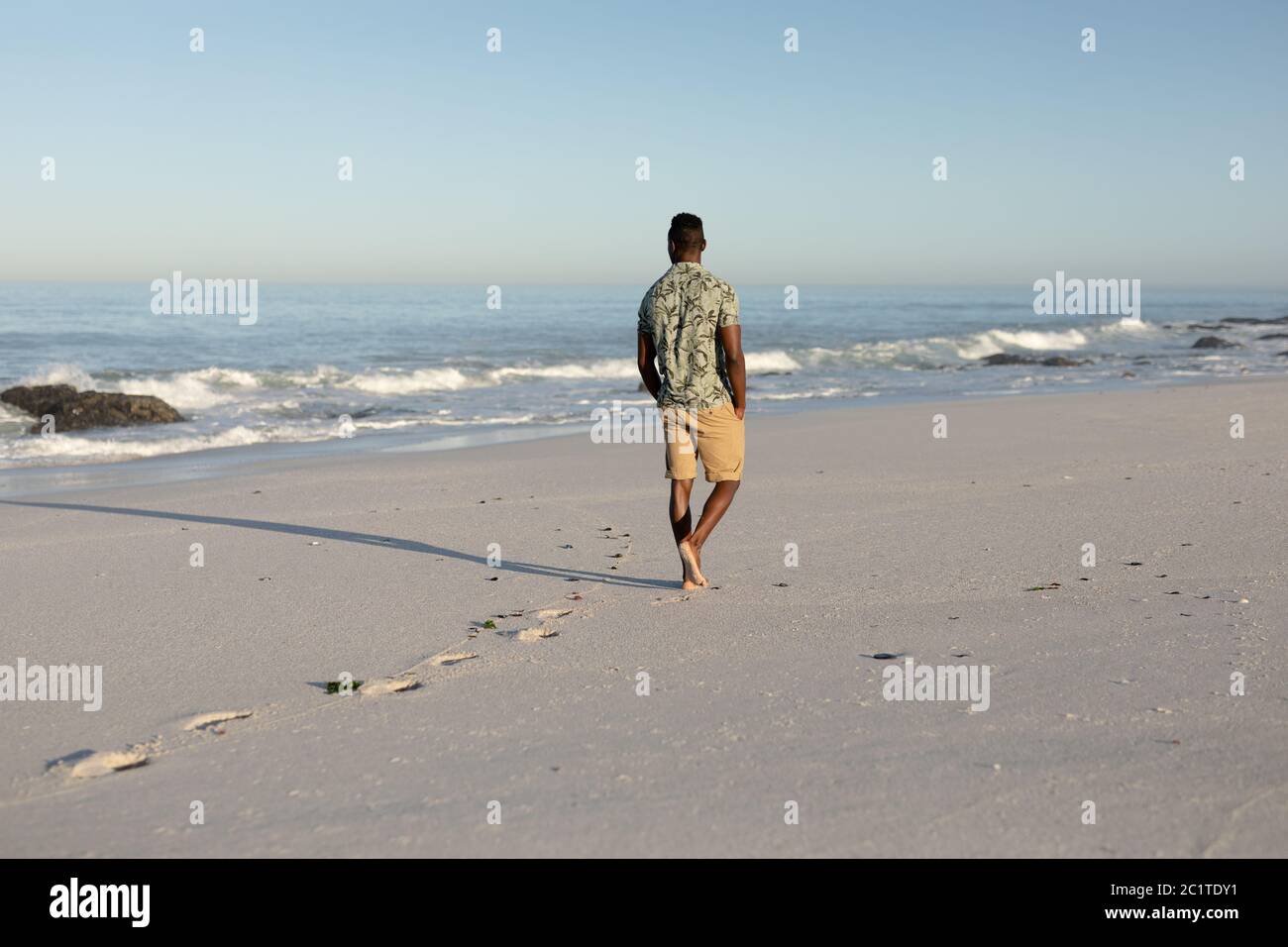 Man walking tropical beach hi-res stock photography and images - Alamy