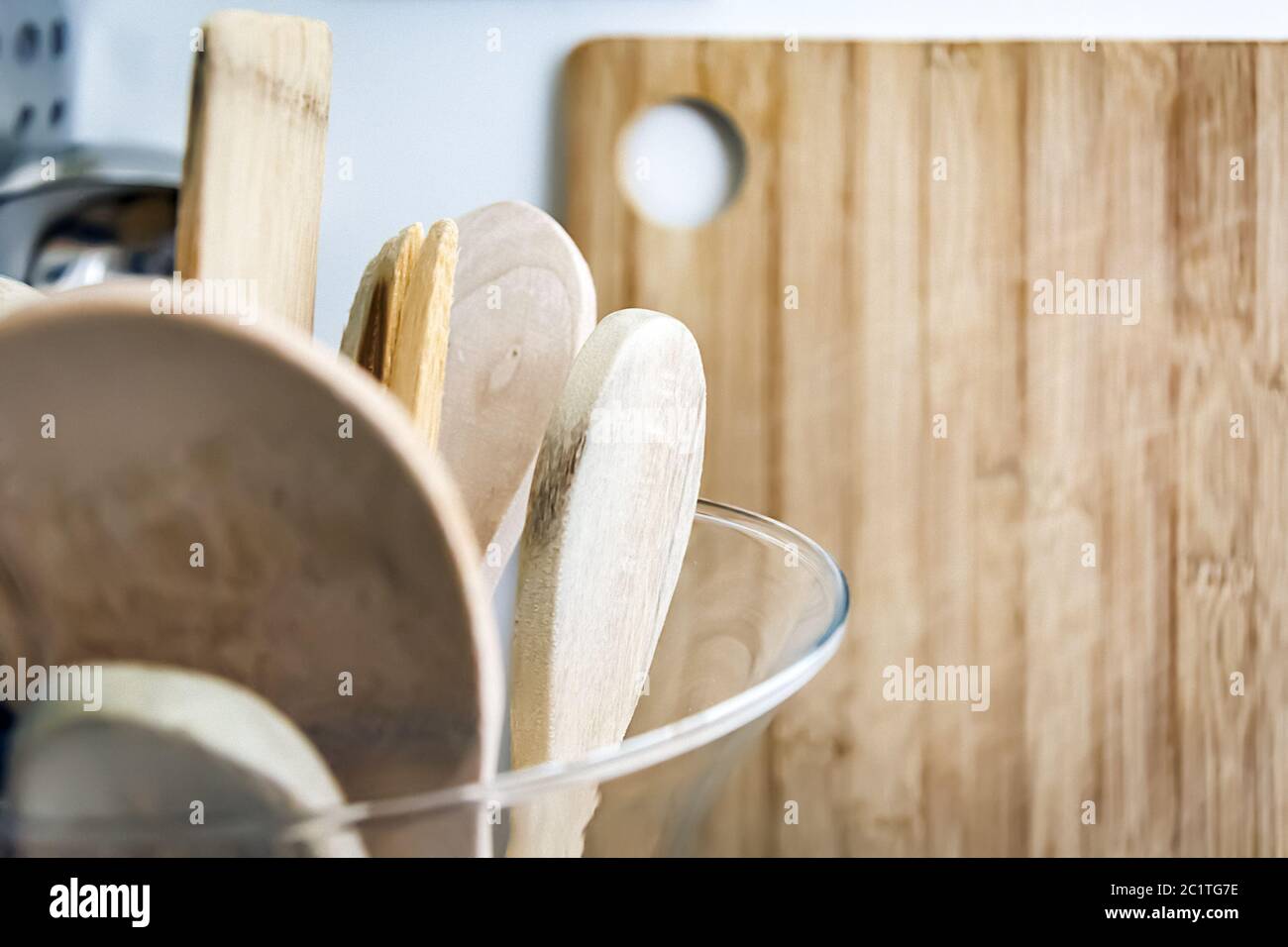 Wooden kitchen utensils in a glass container Stock Photo Alamy