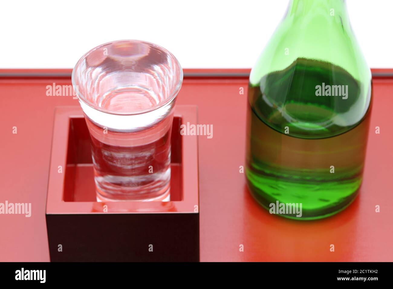Japanese wooden box masu with sake on wooden tray, on white background