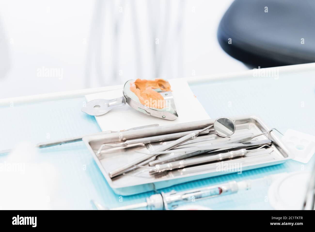 Close-up of a common stamotological instrument next to a metal form for prosthetics. Dental equipment. Dental hygiene and health Stock Photo