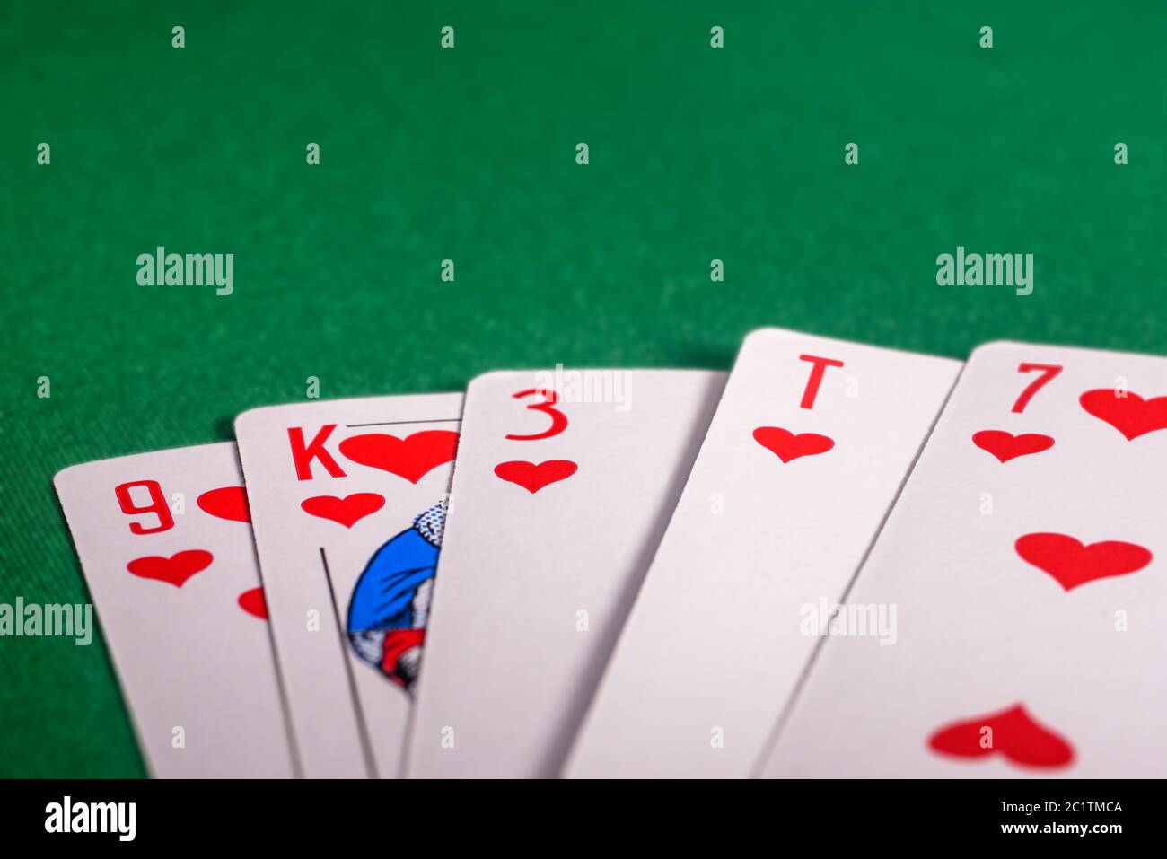 playing cards on the green table. Combination 'flush' in poker Stock Photo