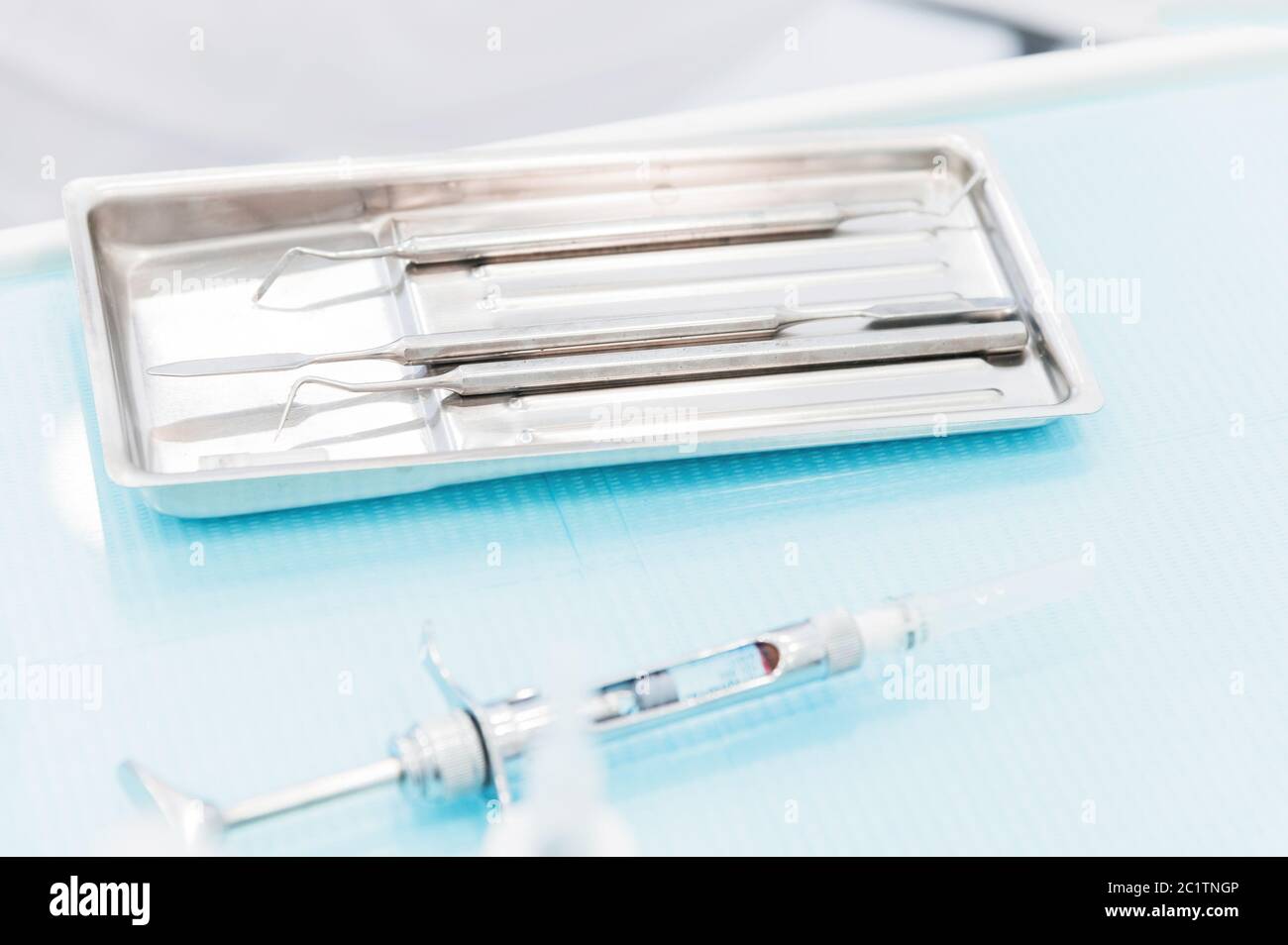 Close-up of a staminological instrument next to a metal syringe. Dental equipment. Dental hygiene and healthcare concept Stock Photo