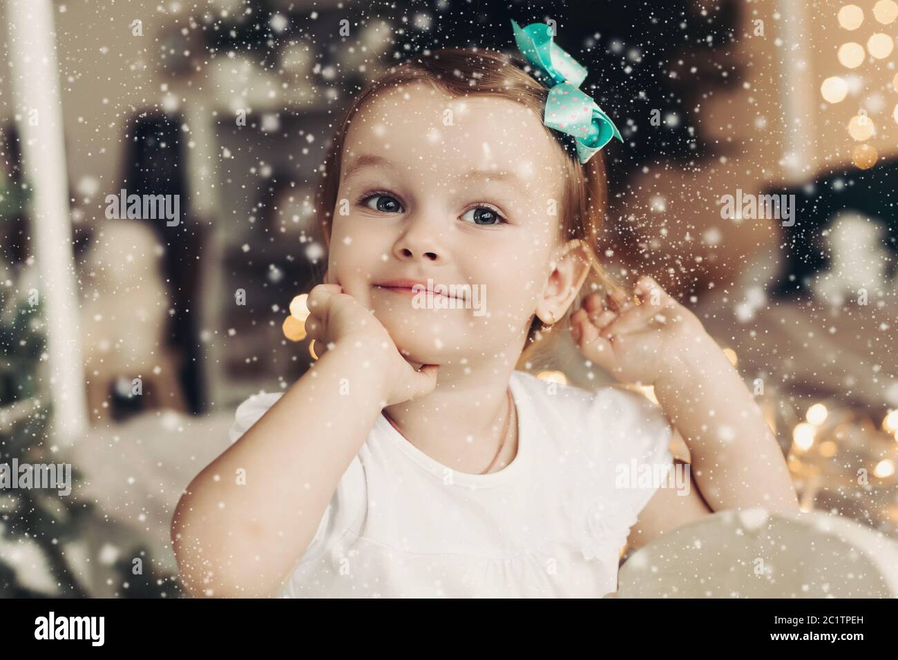 Adorable little girl with bow on head posing Stock Photo - Alamy