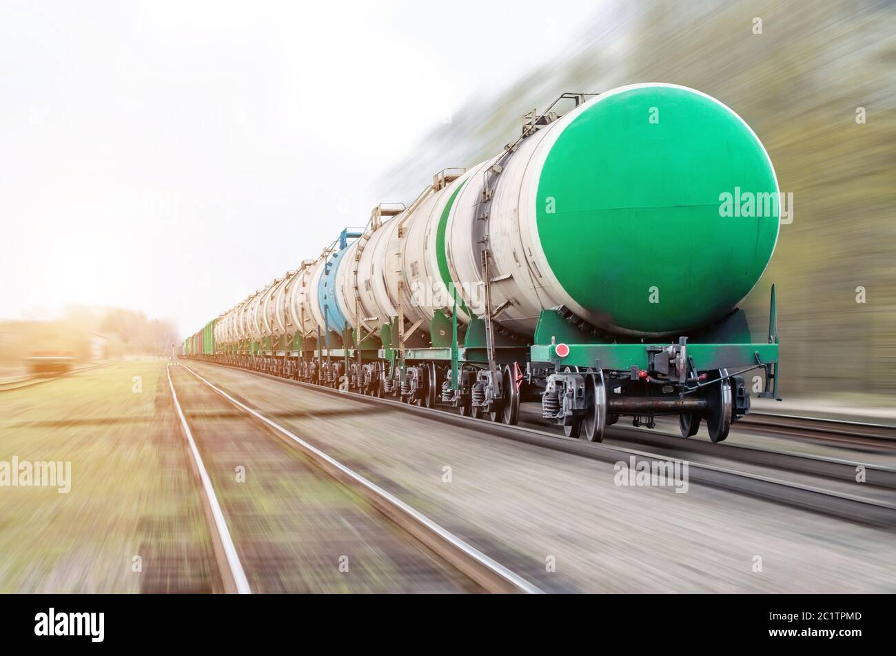 Freight train passing oilloading, fuel oil, fuel tanks in motion Stock