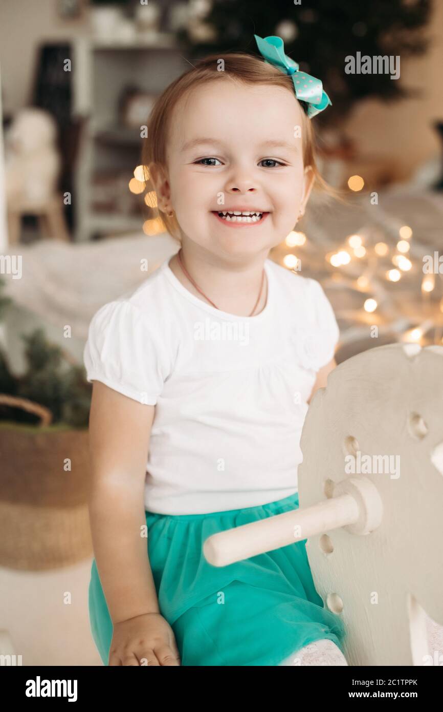 Adorable little girl with bow on head posing Stock Photo - Alamy