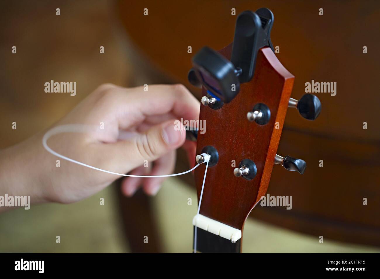 Process of changing string of ukulele Stock Photo Alamy