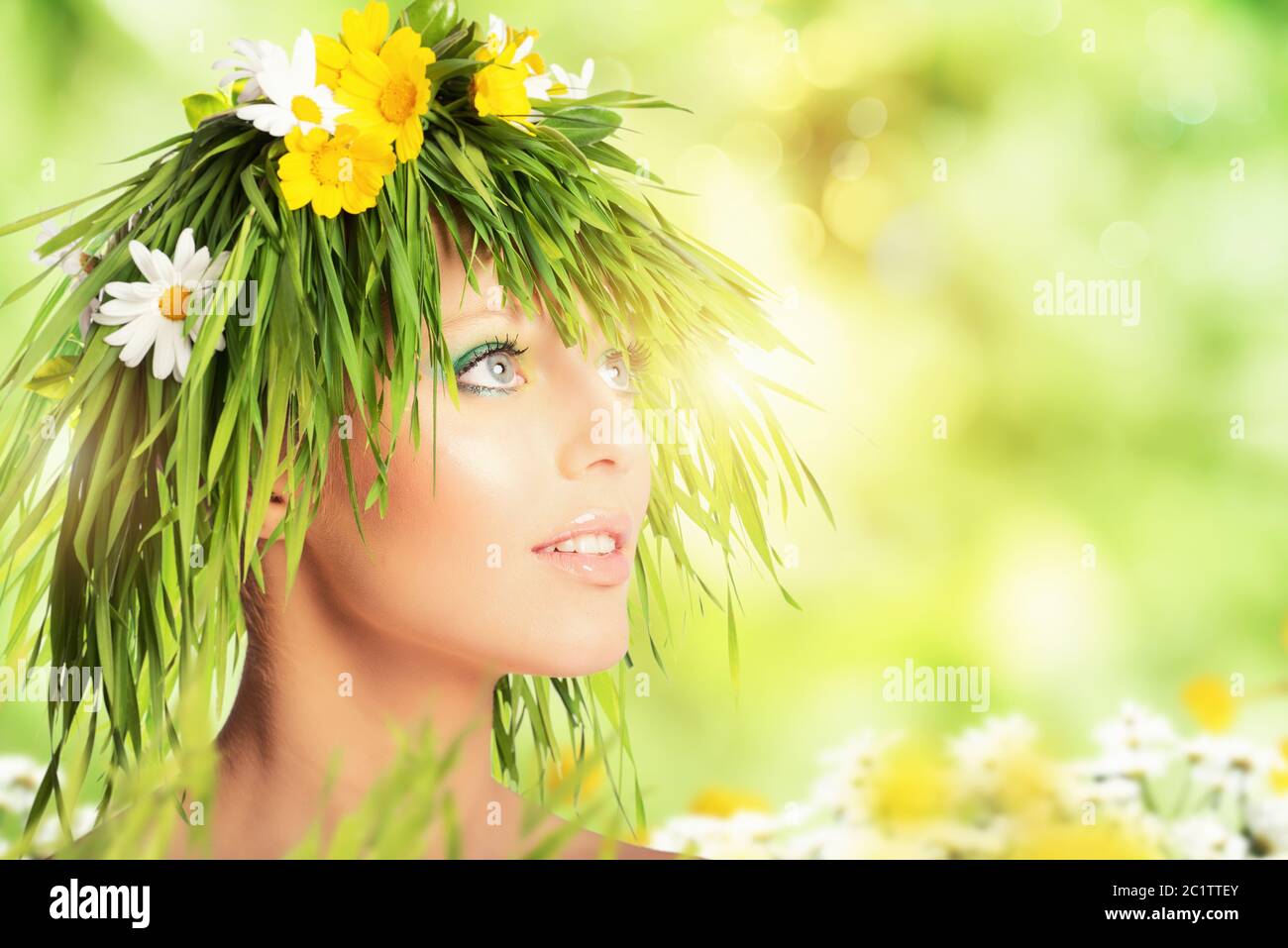 Mother nature beauty concept with girl hair made of flowers and grass. Stock Photo