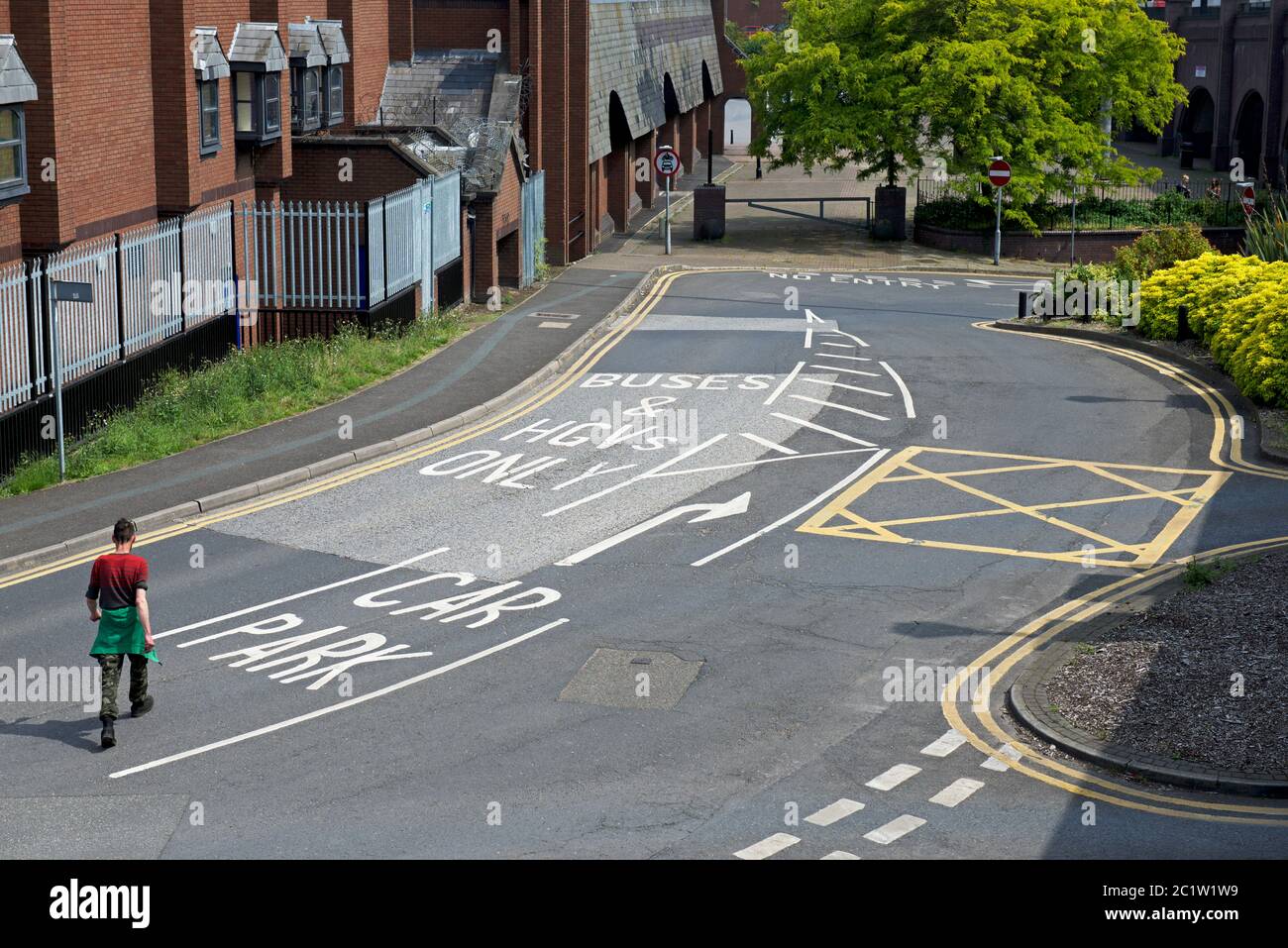 Man walking across road junction in Doncaster, South Yorkshire, England UK Stock Photo