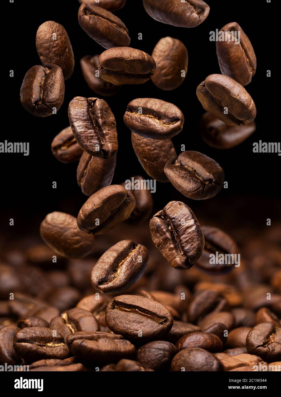 Falling coffee beans. Dark background with copy space Stock Photo - Alamy