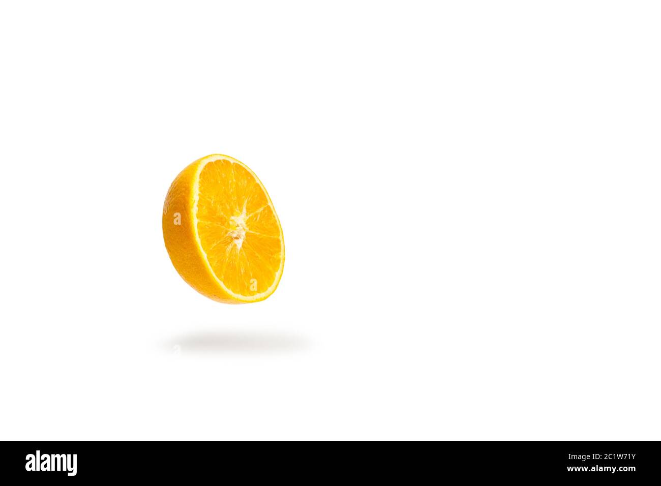 A half orange floating on a white background with shadow bellow Stock Photo