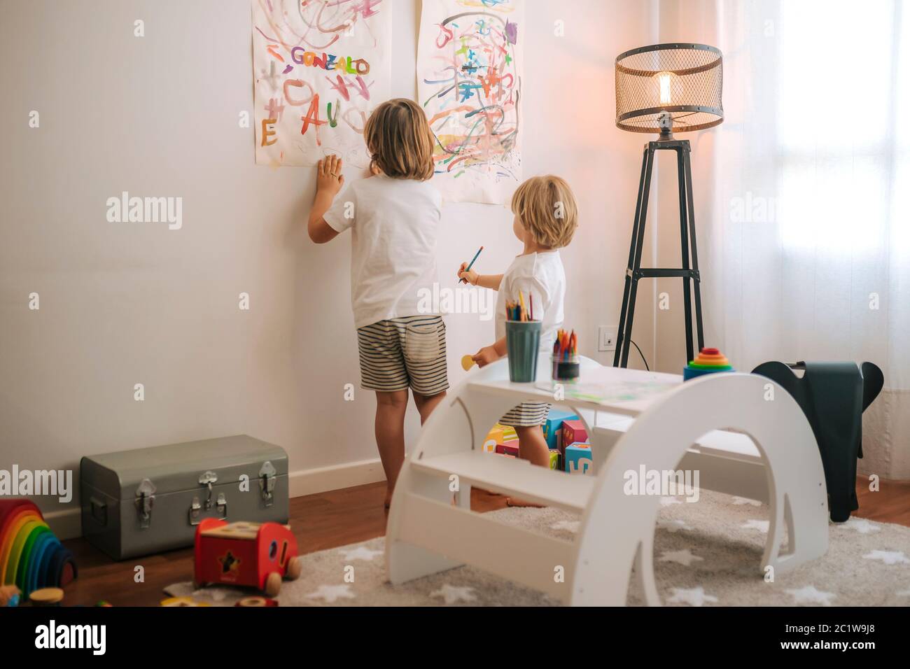 Little blond children plays painting at home. entertainment during quarantine. family at home coronavirus. Stock Photo