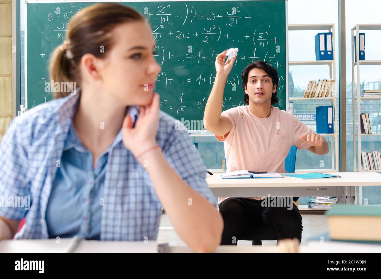 Young students taking the math exam in classroom Stock Photo