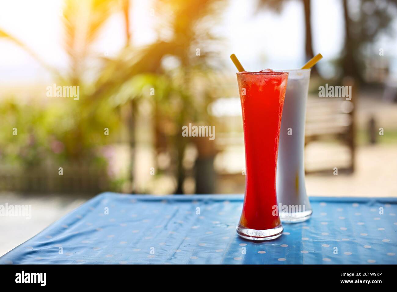 Tequila sunrise and pina colada cocktails under the palm Stock Photo