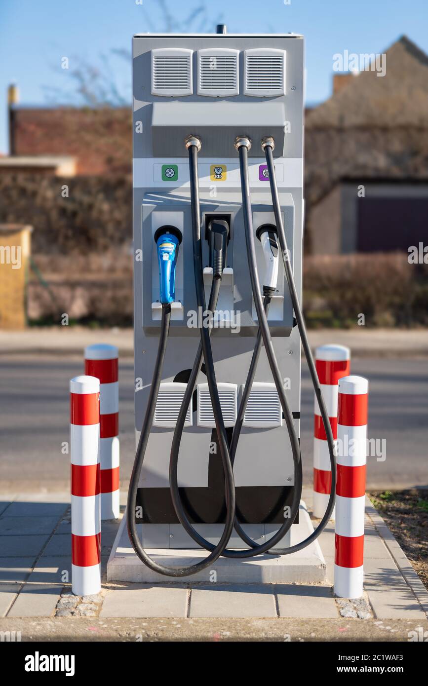 Charging station for an electric vehicle with 3 different connectors Stock Photo