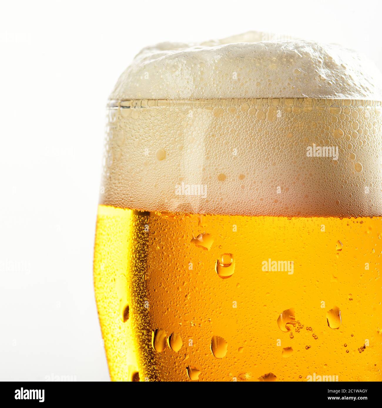 misted beer glass with foam closeup on white background Stock Photo Alamy