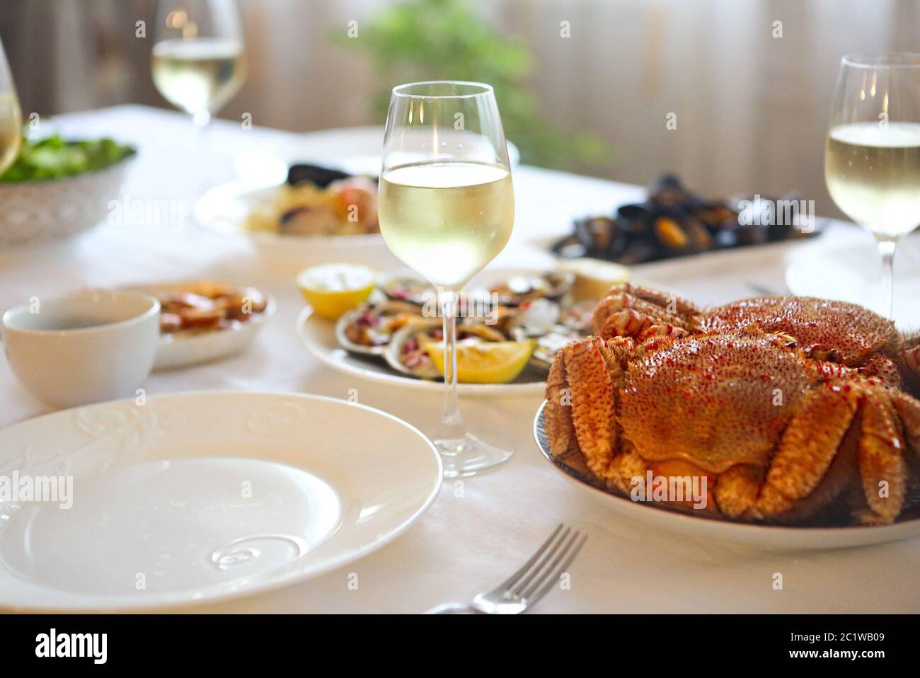 People fine dining seafood and white wine Stock Photo - Alamy