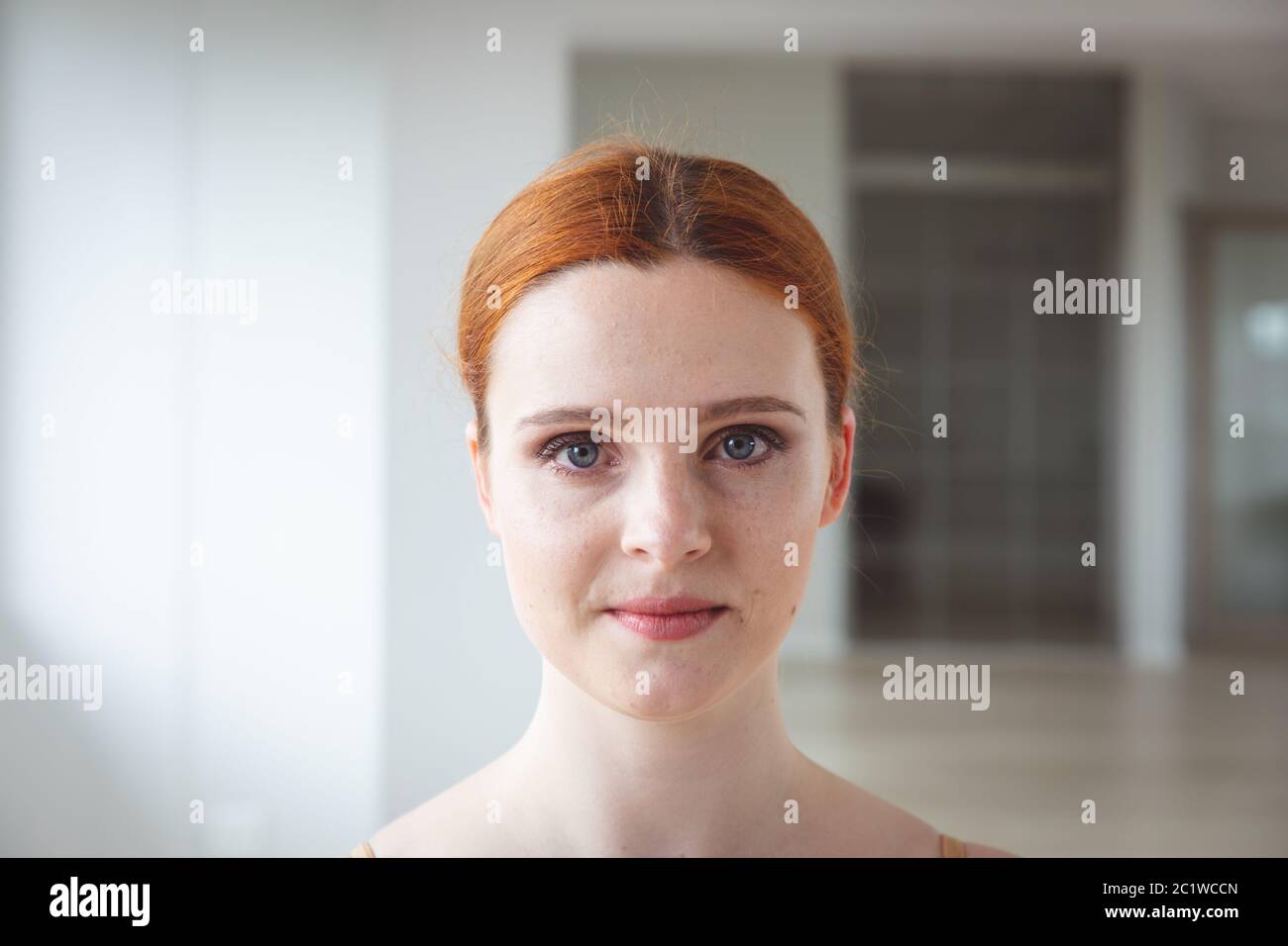 Caucasian female ballet dancer staring into the camera with a serious face Stock Photo