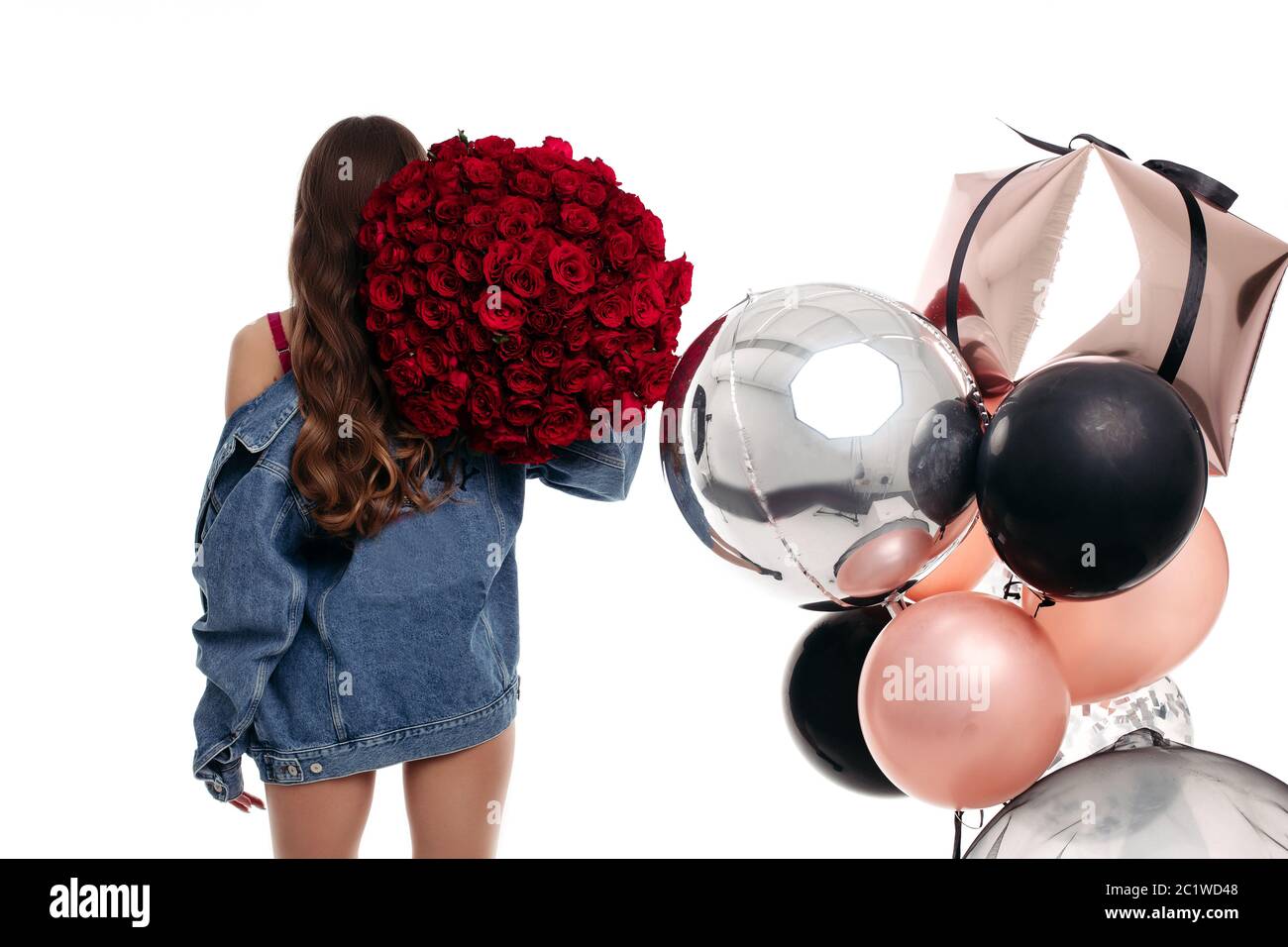 Brunette girl with long hair getting presents on birthday. Stock Photo