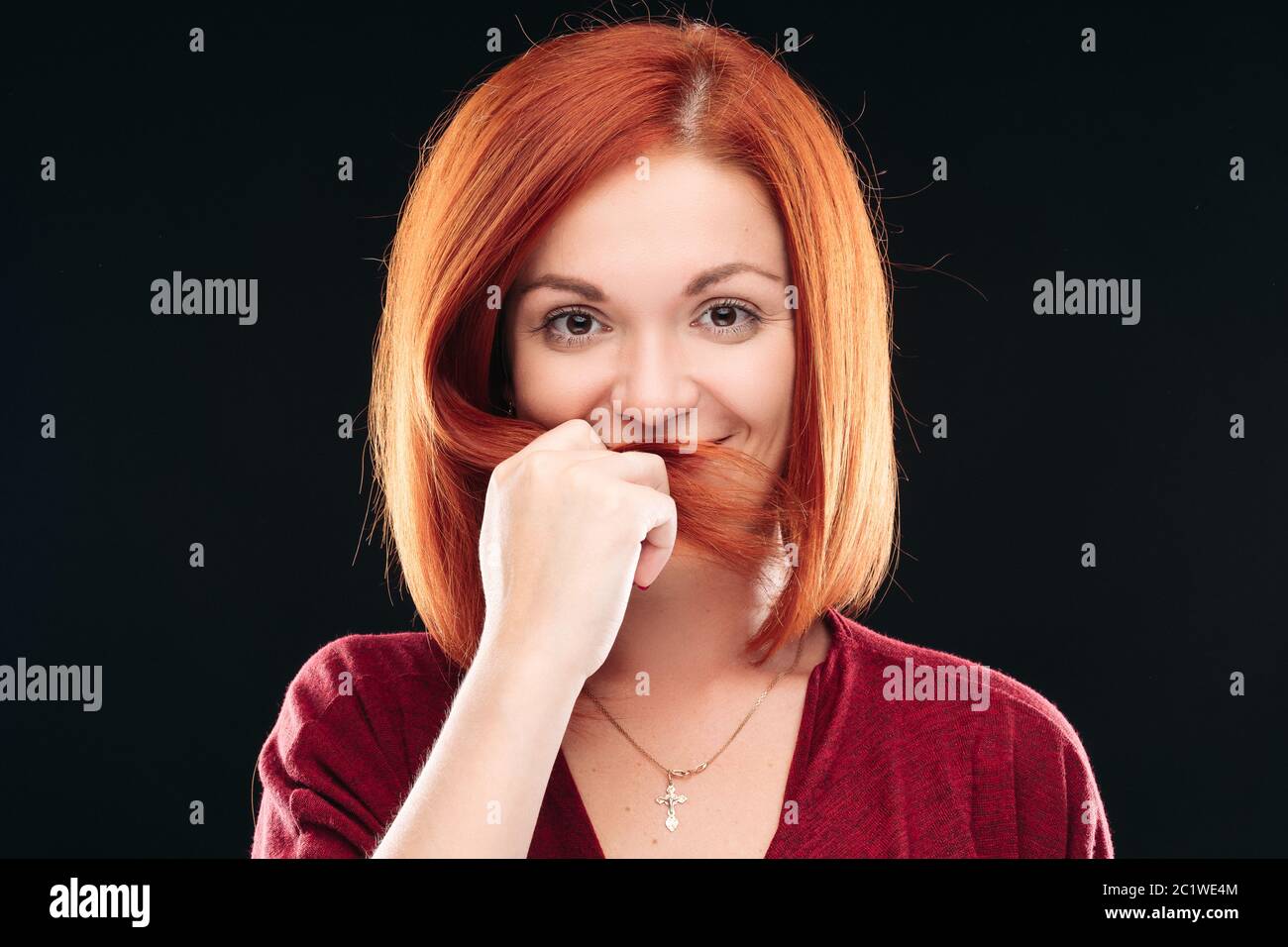 girl having straight ginger hair looking at camera Stock Photo