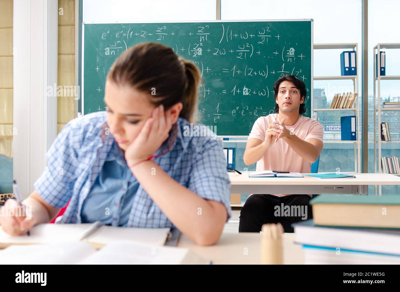Young students taking the math exam in classroom Stock Photo