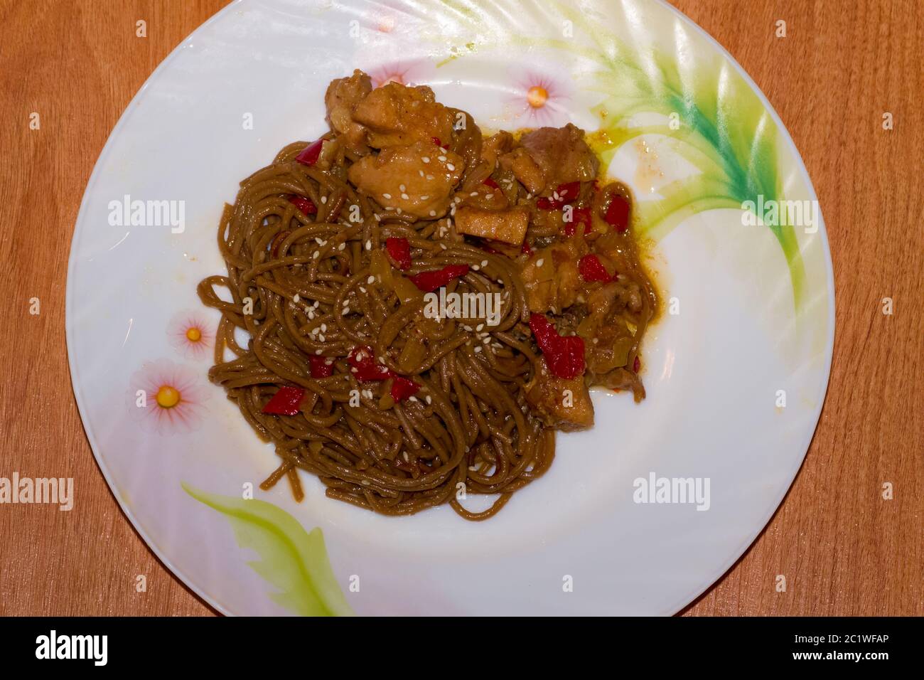 Plate with yakisoba on wooden background Stock Photo