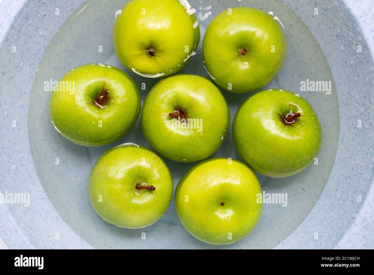 Soak green apples in water. Washing fruit concept Stock Photo Alamy