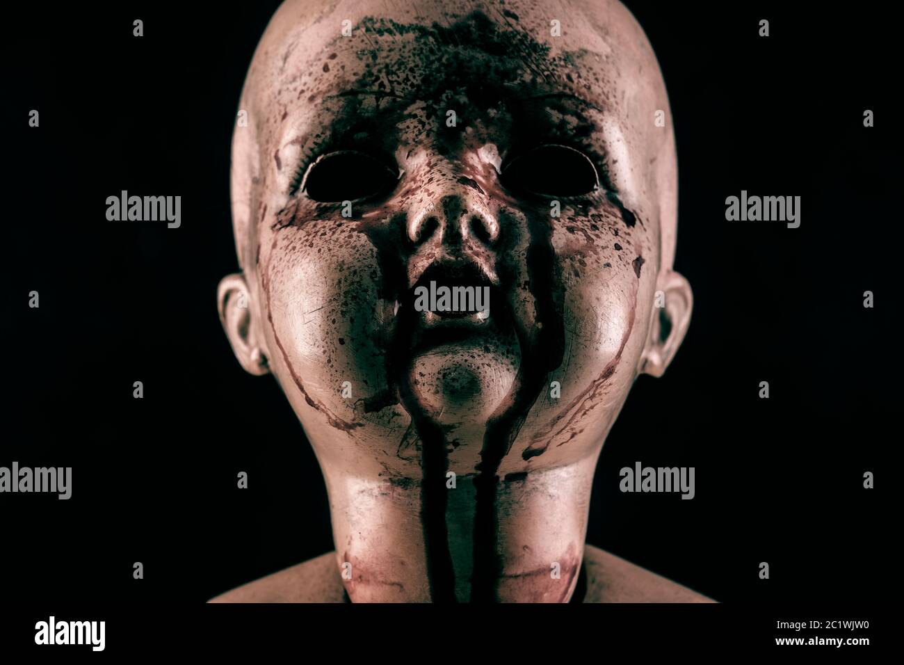 Creepy bloody doll in the dark Stock Photo