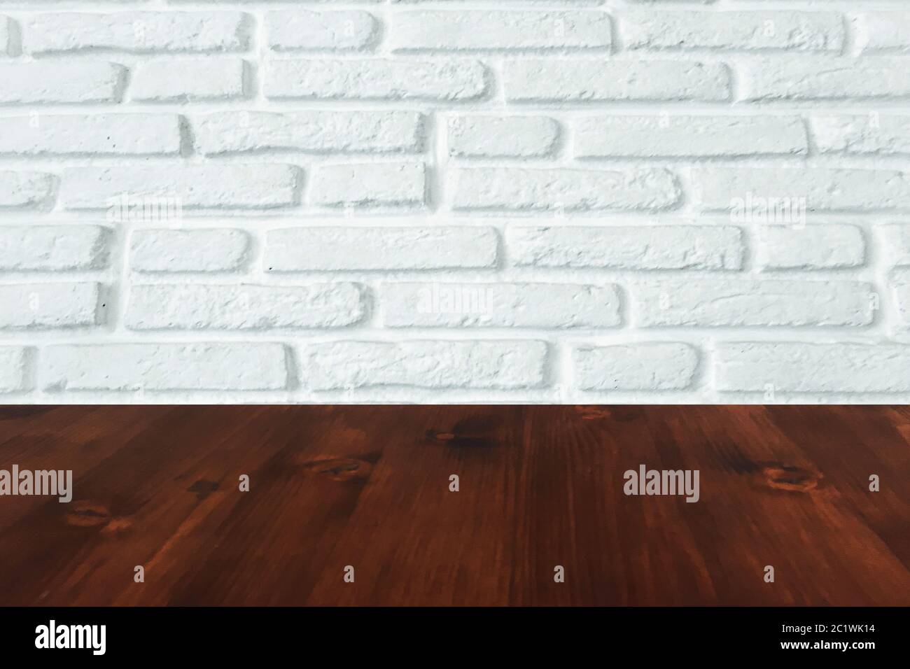 brown wood table with white brick wall texture background. Stock Photo