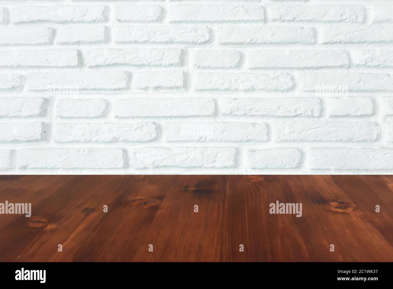 brown wood table with white brick wall texture background. Stock Photo