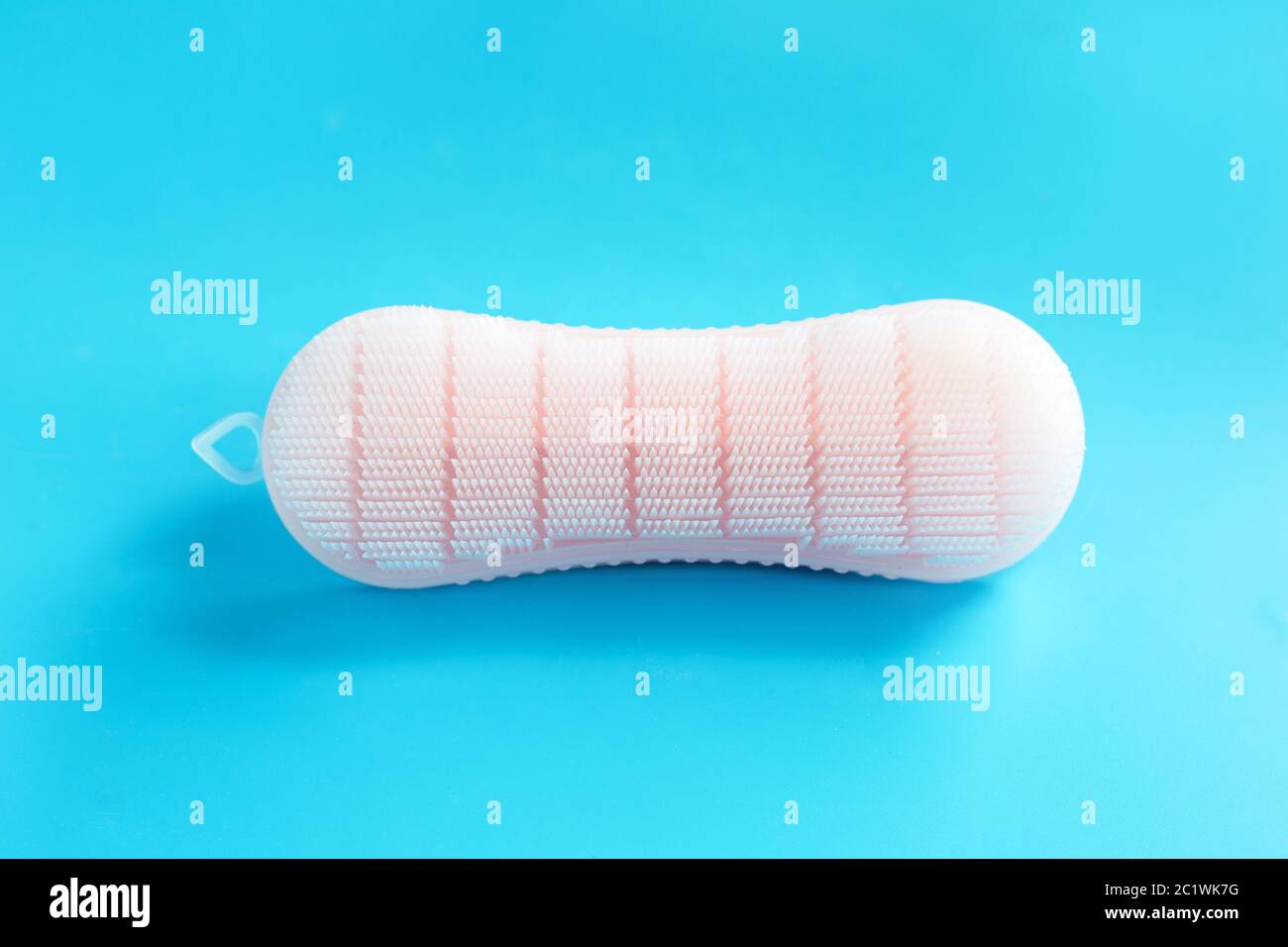 Brush for cleaning clothes on blue background. Stock Photo
