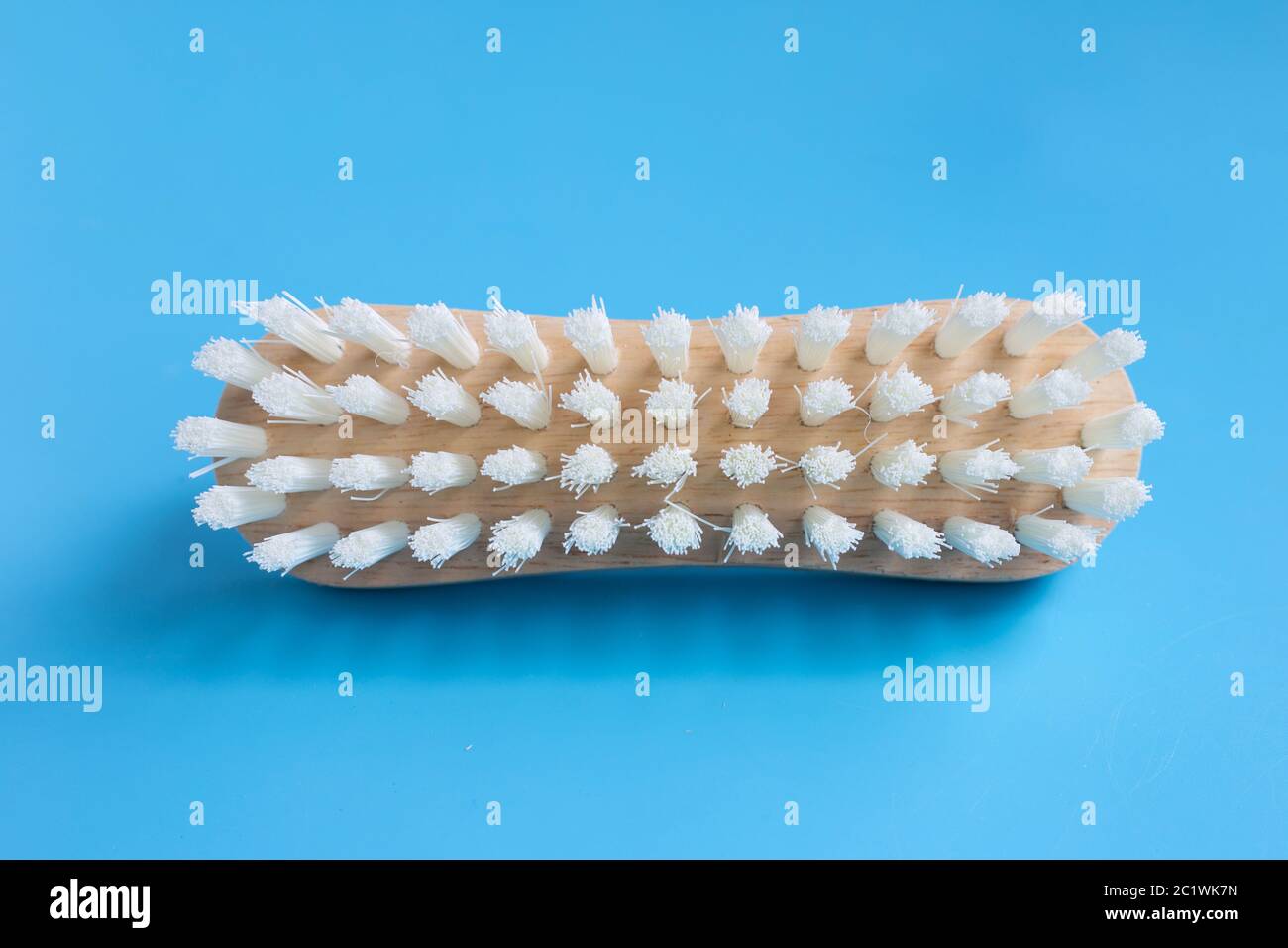 Brush for cleaning clothes on blue background. Stock Photo