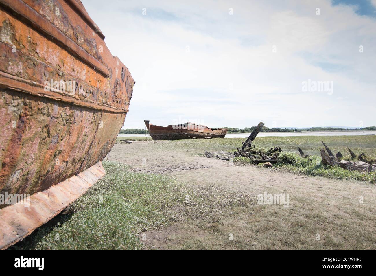 Two rusty old shipwrecks by a river Stock Photo