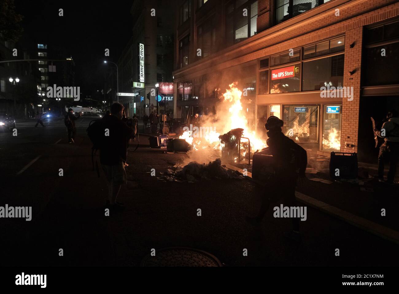 Portland, USA. 15th June, 2020. Trash cans burn on Southwest 3rd and Taylor during the eighteenth night of demonstrations against police brutality in Portland, Ore., on June 15, 2020. (Photo by Alex Milan Tracy/Sipa USA) Credit: Sipa USA/Alamy Live News Stock Photo