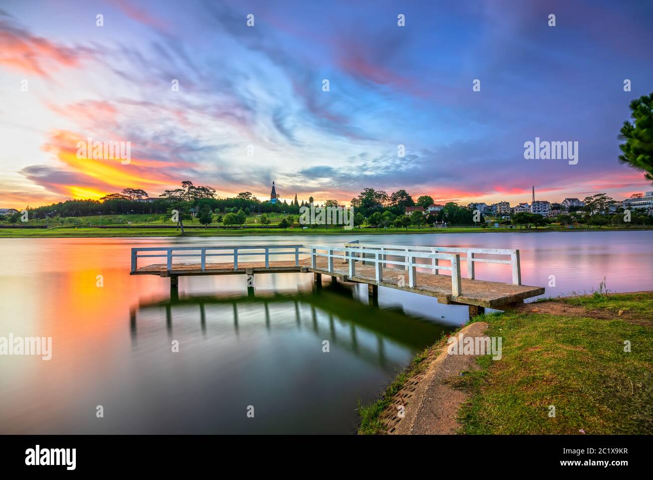 Sunrise on the small bridge overlooking the lake with the dramatic sky welcomes new day in the tourist city of Vietnam Stock Photo