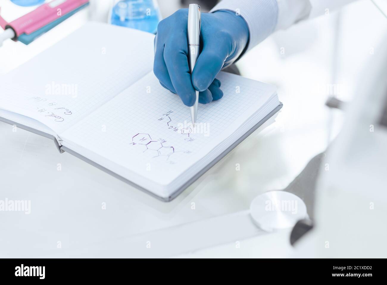 close up. female scientist writing research results in a notebook. Stock Photo