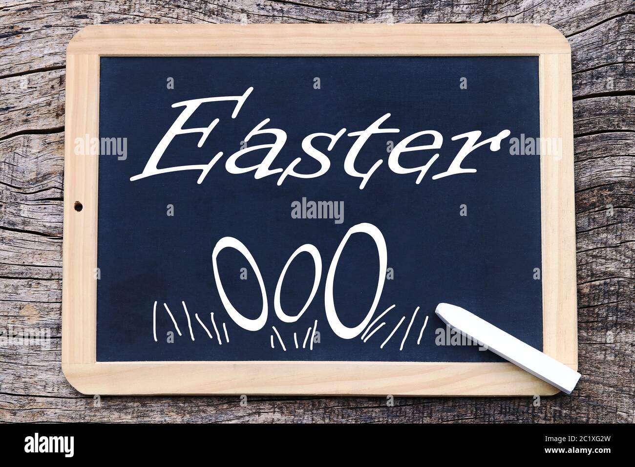 Easter and Easter eggs written and painted on a blackboard Stock Photo