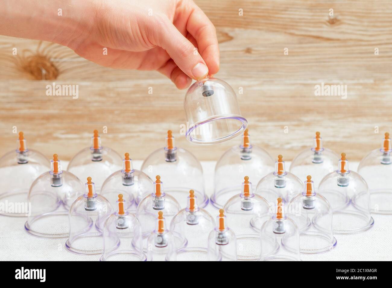 Hand taking vacuum massage glass jar from medical set of traditional