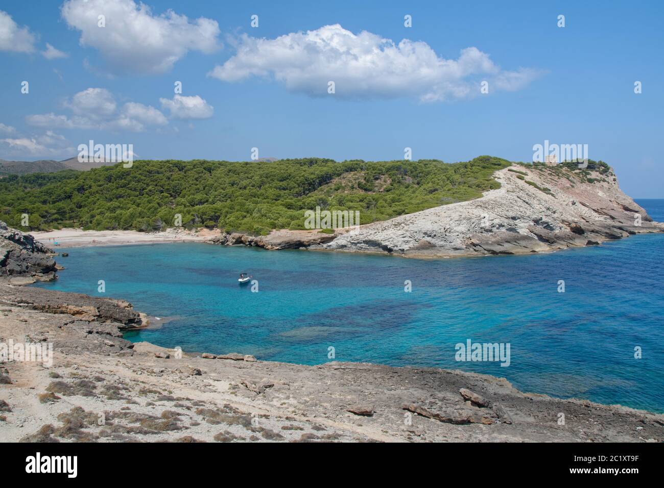 View along coastal footpath towards Cala Matzoc beach and Torre D’Aubarca medieval watchtower, Llevant Peninsula Natural Park, near Arta, Mallorca eas Stock Photo