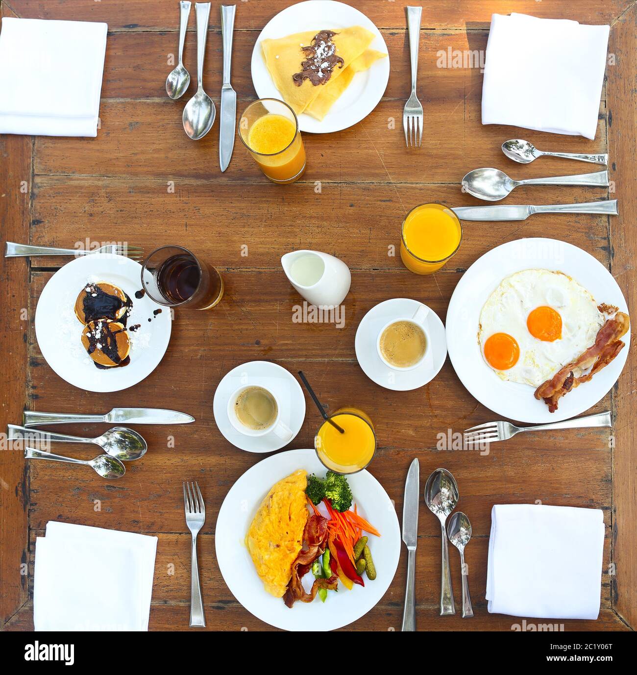 Continental breakfast with pancakes, eggs, bacon, orange jiuce and coffee Stock Photo